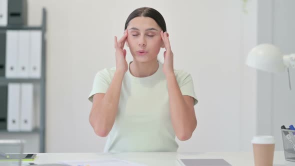 Tired Young Latin Woman Having Headache in Office alt