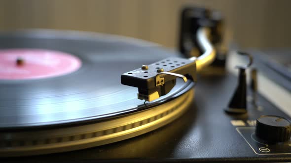 The Vinyl Record on DJ Turntable Record Player Close Up. The Rotating Plate and Stylus