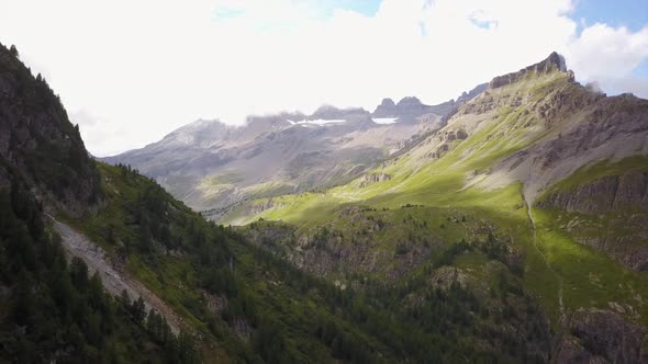 View of a mountain range in the swiss alps. aerial drone view. cloudy day in summer alt