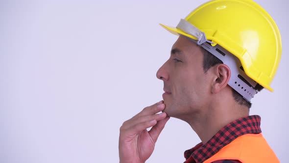 Closeup Profile View of Young Happy Hispanic Man Construction Worker Thinking