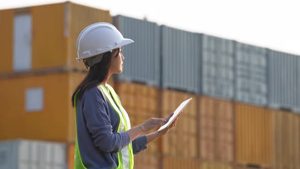 Worker woman checking and control loading containers box from cargo