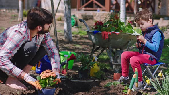 In the Garden Man and His Son Have a Chat While alt