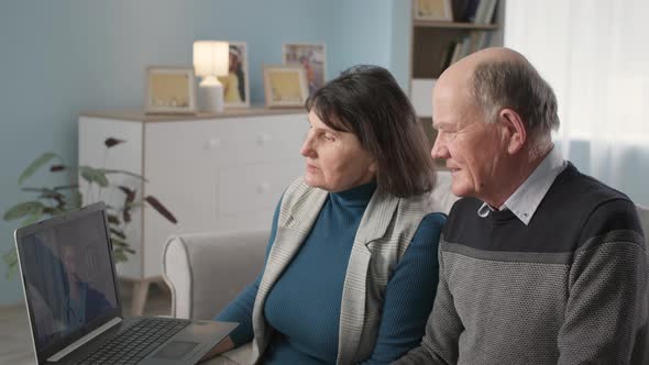 Male and Female Retirees at Medical Consultation are Talking on Webcam with Attending Physician alt