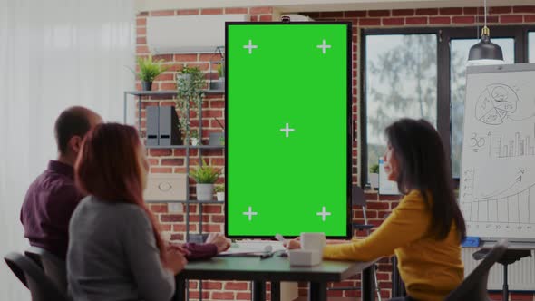 Employees Using Green Screen on Monitor Vertically in Boardroom alt