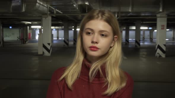 Young Woman Walking Alongside Parking Lot