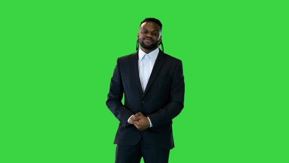 Black Man in Office Suit Telling Something in Front of Camera on a Green Screen Chroma Key alt