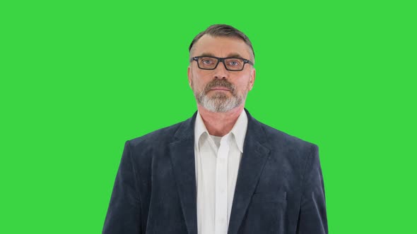 Senior Business Man Walking with Briefcase on a Green Screen Chroma Key alt