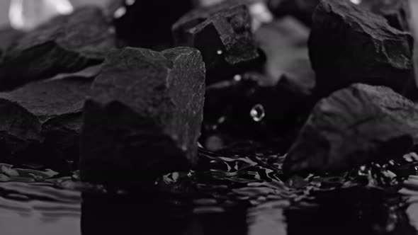 Super Slow Motion Shot of Coal Falling Into Water at 1000 Fps. alt