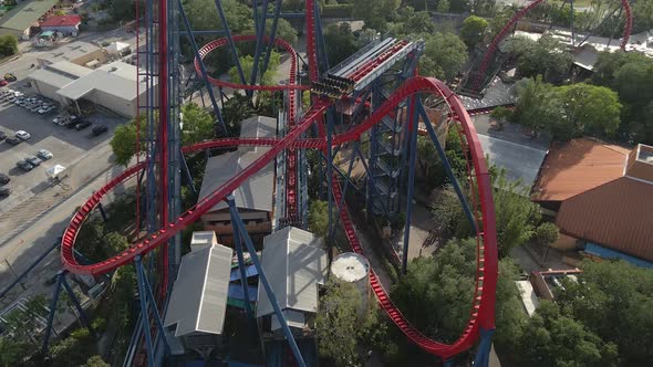 Aerial view of people riding an extreme roller coaster in a theme park, Tampa, Florida alt