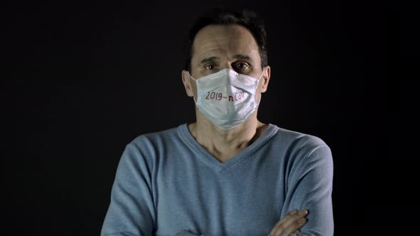 Man in Medical Mask Breathes Deeply, Isolated, Coronavirus Covid-19 Concept alt