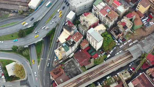 Aerial top down view of yellow taxi cabs crossing a interconnected highway loop surrounded by old Eu alt