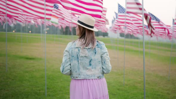 Slow Motion Camera Following Woman Walking By Memorial Park on Cloudy Evening alt