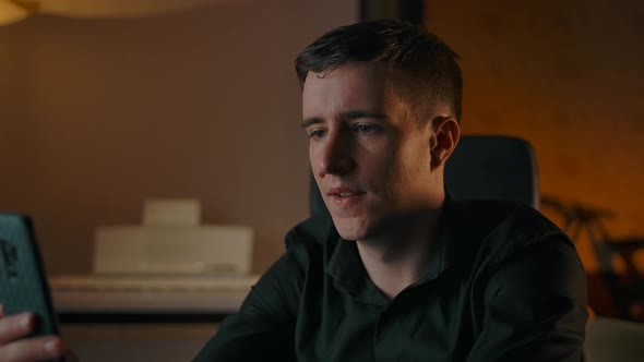 Happy Male Have Conversation Via Video Call Indoor of Cozy Home Interior alt