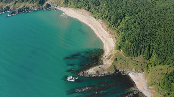 Drone flight above a picturesque rocky coastline alt