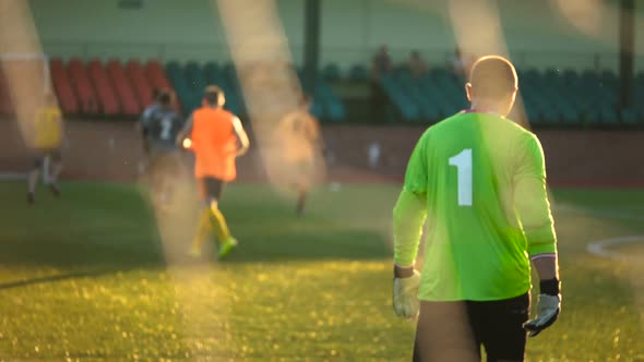 Goalkeeper Walks in Slow Motion, Rear View, Team Playing Match, Amateur Championship, Digit 1 on alt