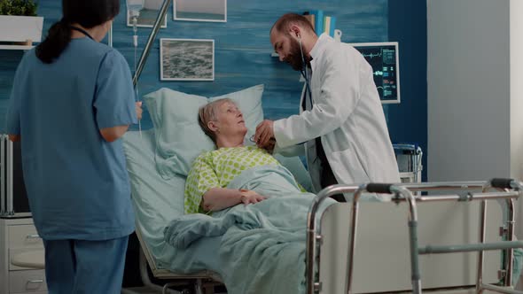 Doctor Using Stethoscope for Heartbeat Checkup on Ill Patient alt