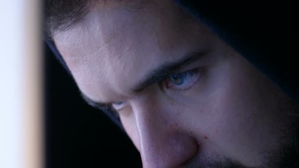 Close up On Hacker Face Focused on Attacking the System on Computer alt