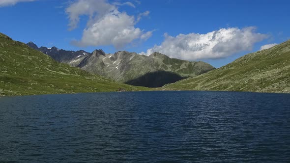 Scenic view on peak of mountains and lake in Swiss Alps