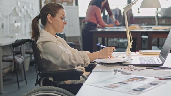 Female Fashion Designer in Wheelchair Working alt