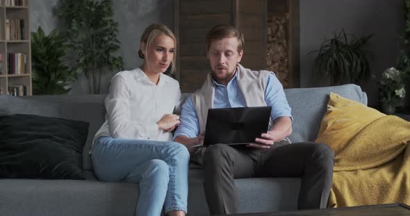Husband and Wife Discussing Online Shopping Together Surfing Internet Use Laptop alt