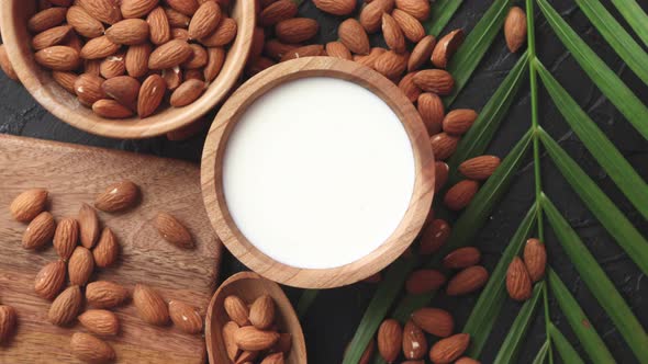 Close Up of Almonds in Wooden Bowl and Almond Milk