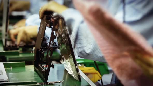 Workers in the Production Line of a Laptop Factory. Fast Motion. 4K Version. alt
