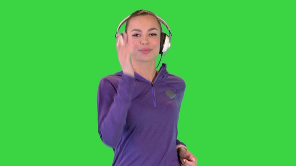 Sporty Woman Listening Music in Headphones While Running on a Green Screen Chroma Key alt