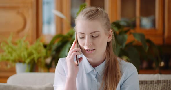 Woman Talking on Mobile at Home alt