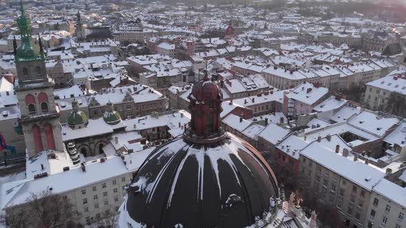 Aerial shot flying around cathedral dome in the center part of Lviv.