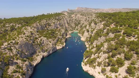 Aerial travel drone view of clear green water, cliffs of Cassis, Mediterranean Sea, Southern France. alt