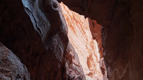 Sun's Rays Enter Through an Opening High Up in Cave in a Mountain in the Desert alt