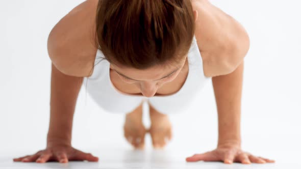 Senior Woman in White Space Practice Yoga Up Dog Position