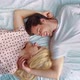 Smiling Romantic Couple Lying in Bed Face to Face in Opposite Directions - VideoHive Item for Sale