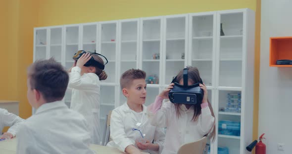 Little Children Teens in the Classroom Watching in Virtual Reality Glasses alt