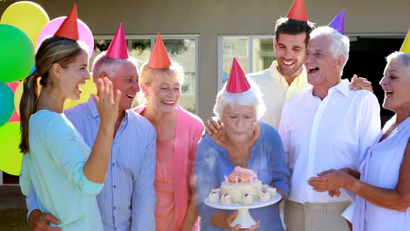 Doctors and senior citizen celebrating birthday alt