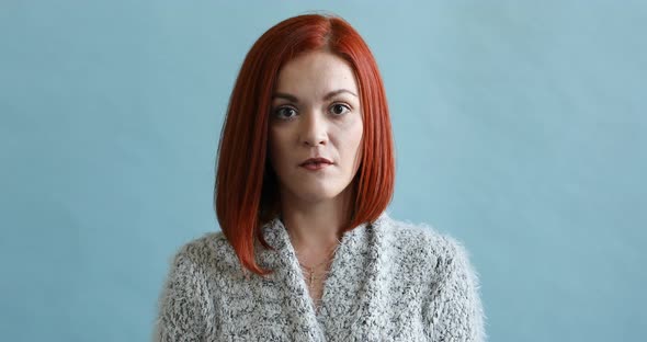 Portrait of a Young Red-haired Woman Being Shocked