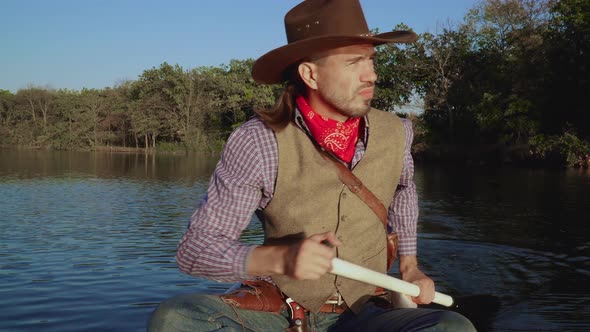 Cowboy in a Canoe Floats on the River alt
