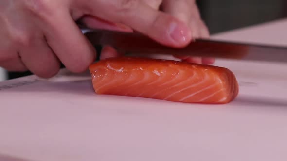 Cutting georgeous red fish fillet into neat slices