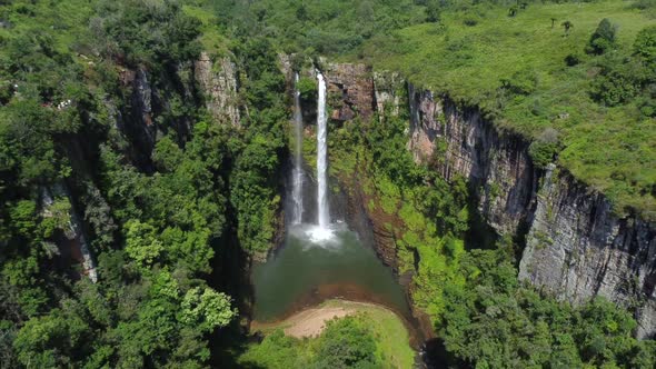 Drone shot of Mac Mac Fall in South Africa - drone is reversing from the waterfall, revealing the va alt