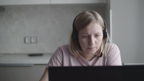 Freelancer Girl Uses Microphone and Headphones