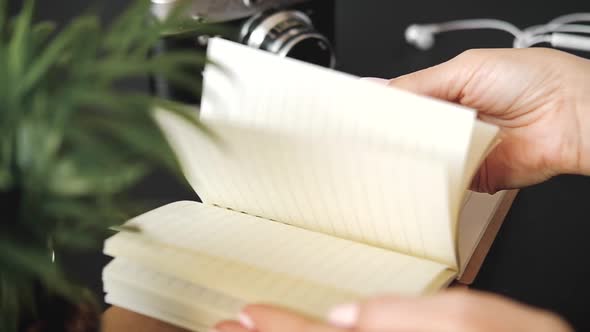 Close-up of the hands of a young unknown woman sitting at a table