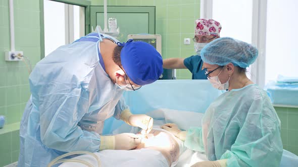 The Surgeon Performs a Surgical Operation