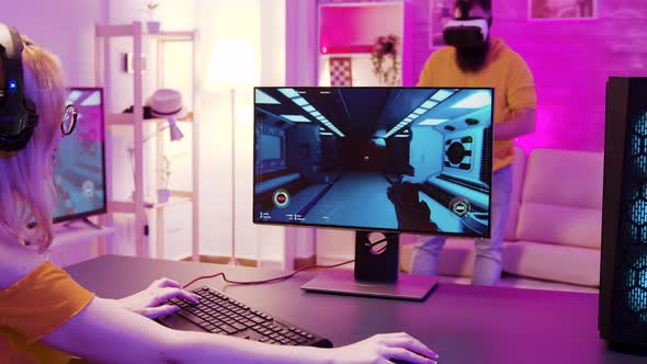 Girl Wearing Headphones and Sitting on Gaming Chair alt