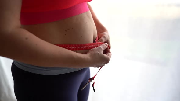 Close Up Frustrated Overweight Woman Measuring Waist alt