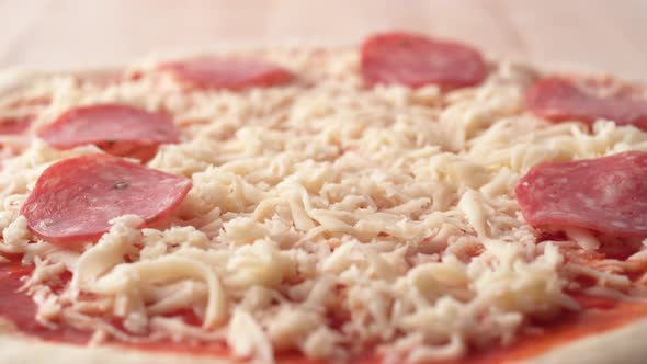 Camera follows putting sliced mushrooms on a pizza dough. Slow Motion. alt
