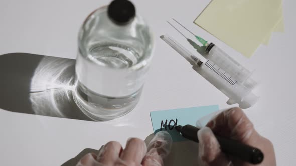 Medic Hands in Gloves Write Inscription of the Monkeypox Virus alt