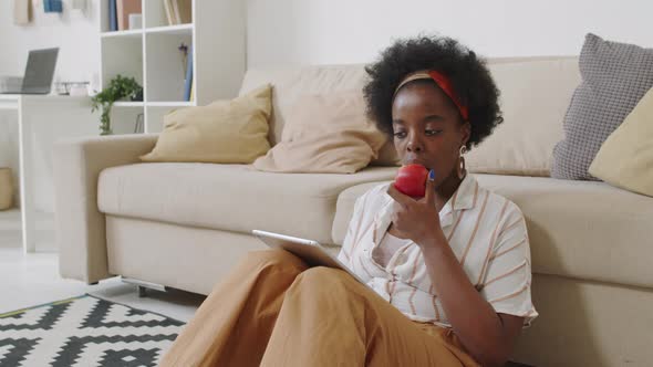 African American Woman Working on Digital Tablet from Home alt