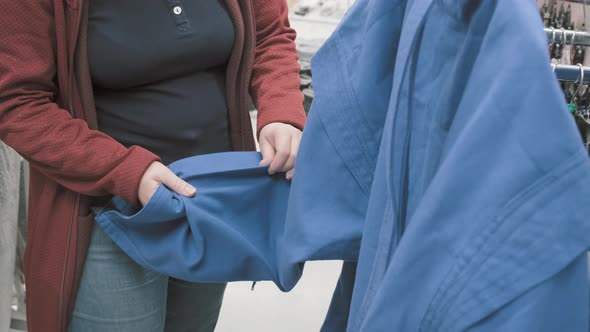 Woman in Store Chooses to Buy Blue Kimono for Wrestling