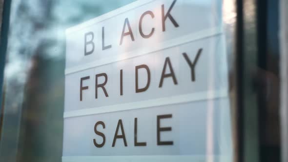 Lightbox Sign Black Friday Sale Behind a Glass Door of the Cafe. Concept Black Friday, Season Sales