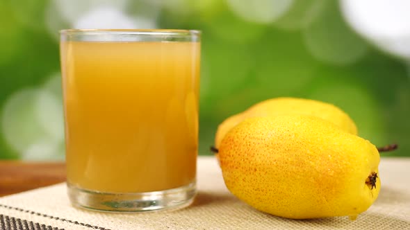 Whole Yellow Pear and Juice in Glass
